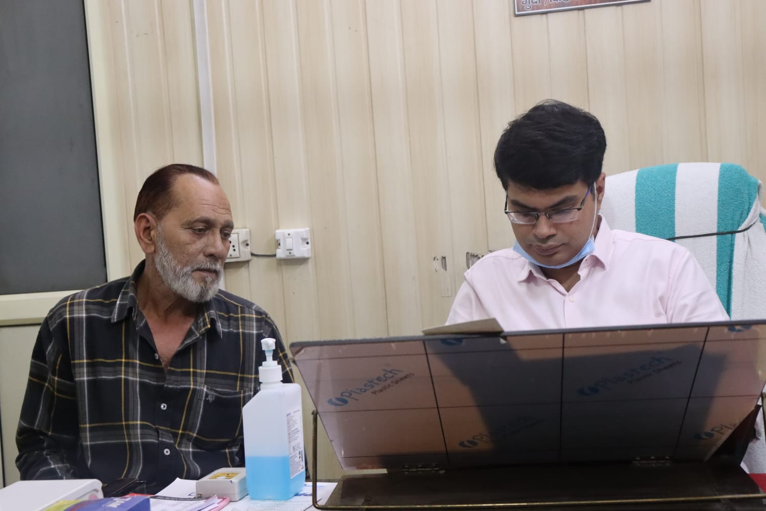 Dr. Vartul Gupta writing prescription